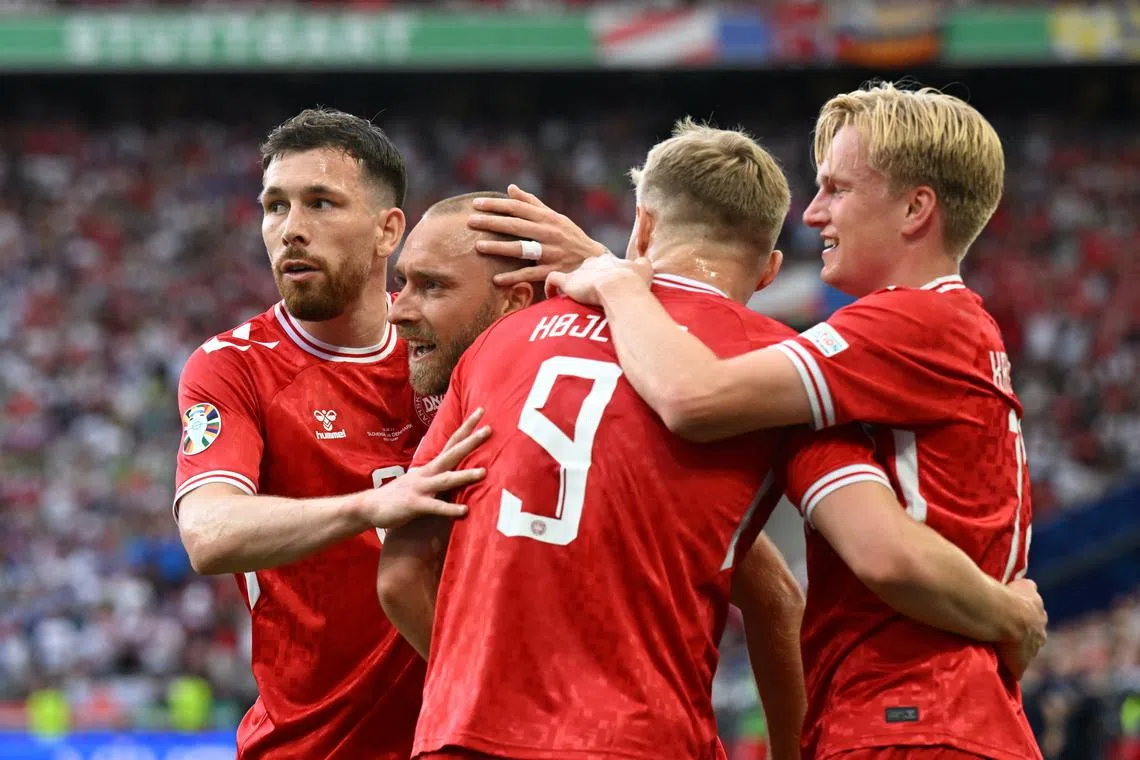 Soccer Football - Euro 2024 - Group C - Slovenia v Denmark - Stuttgart Arena, Stuttgart, Germany - June 16, 2024 Denmark's Christian Eriksen celebrates scoring their first goal with teammates REUTERS/Angelika Warmuth