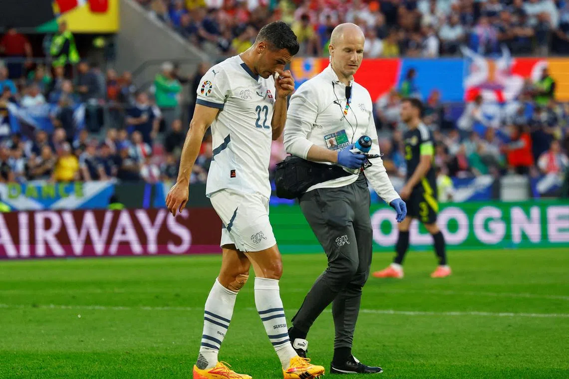 FILE PHOTO: Soccer Football - Euro 2024 - Group A - Scotland v Switzerland - Cologne Stadium, Cologne, Germany - June 19, 2024 Switzerland's Fabian Schar walks off the pitch receiving medical attention REUTERS/Piroschka Van De Wouw/File Photo
