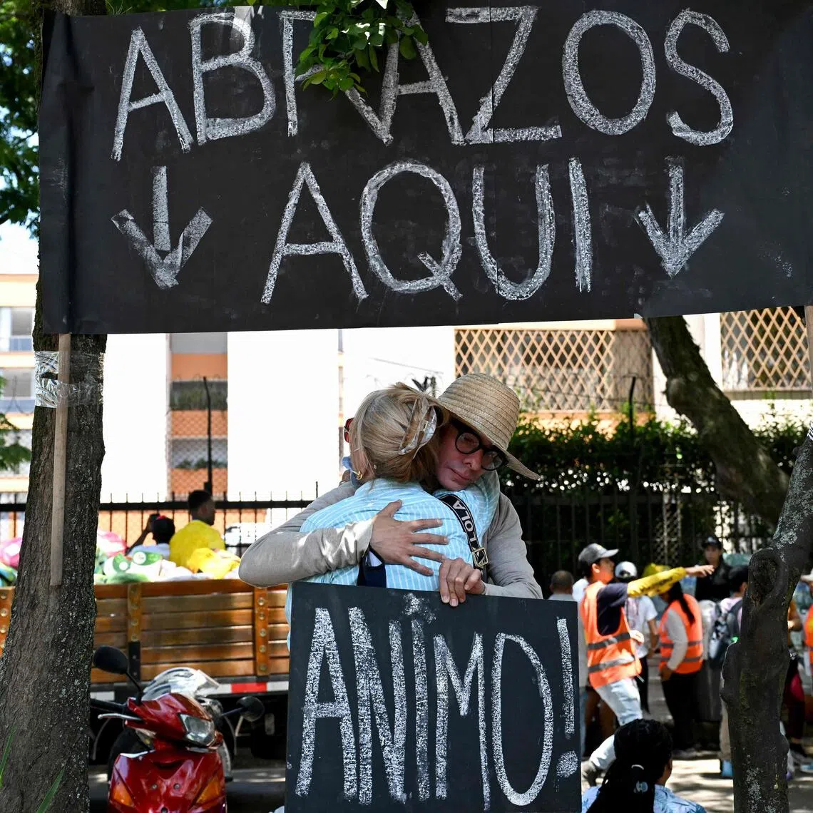 One man offering free hugs spends his days under the shade of trees and a cardboard sign that states: “HUGS HERE.”
