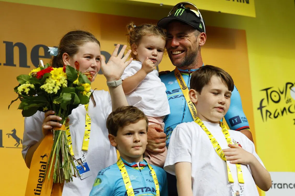 British rider Mark Cavendish of Astana Qazaqstan Team celebrating with his family on the podium after winning the fifth stage of the Tour de France.