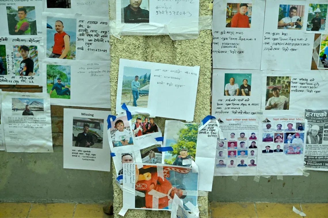 Photos of missing people pasted on the wall at the entrance of Tribhuvan University Teaching Hospital in Kathmandu, Nepal.