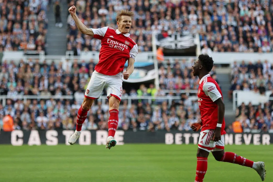 Arsenal's Martin Odegaard celebrates scoring their first goal with Bukayo Saka.