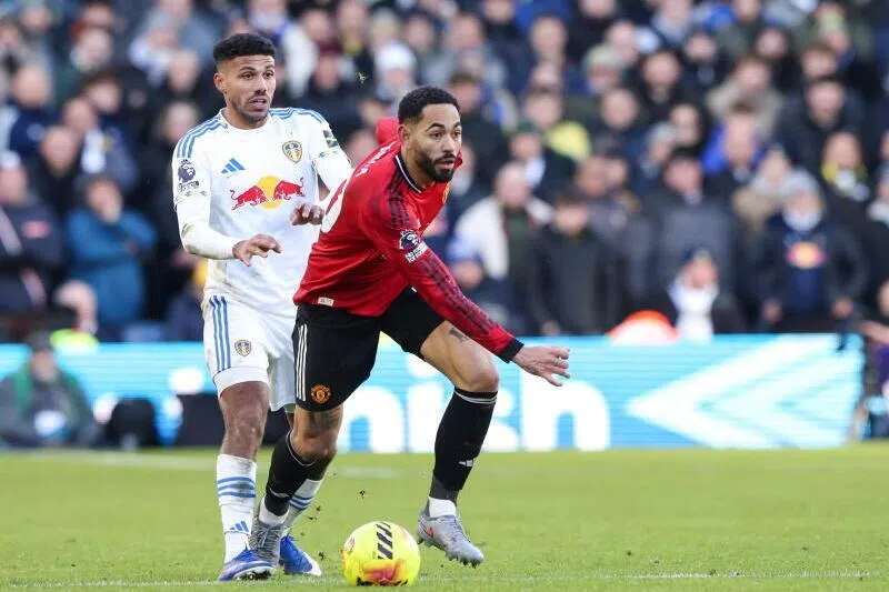 Manchester United's Matheus Cunha shields the ball from Leeds United’s James Justin during the match.