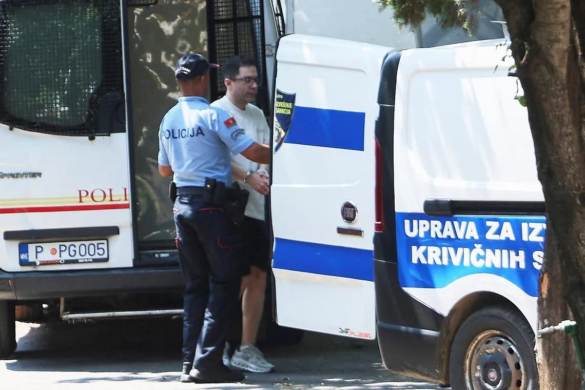 A police officer escorts an Iranian national, who is suspected of hacking attacks that damaged U.S. infrastructure to the tune of $3.4 billion according to  Montenegrin police, and was arrested in a joint operation with the FBI, to an investigating judge on a U.S. extradition request, in Podgorica, Montenegro, June 26, 2026. REUTERS/Stevo Vasiljevic