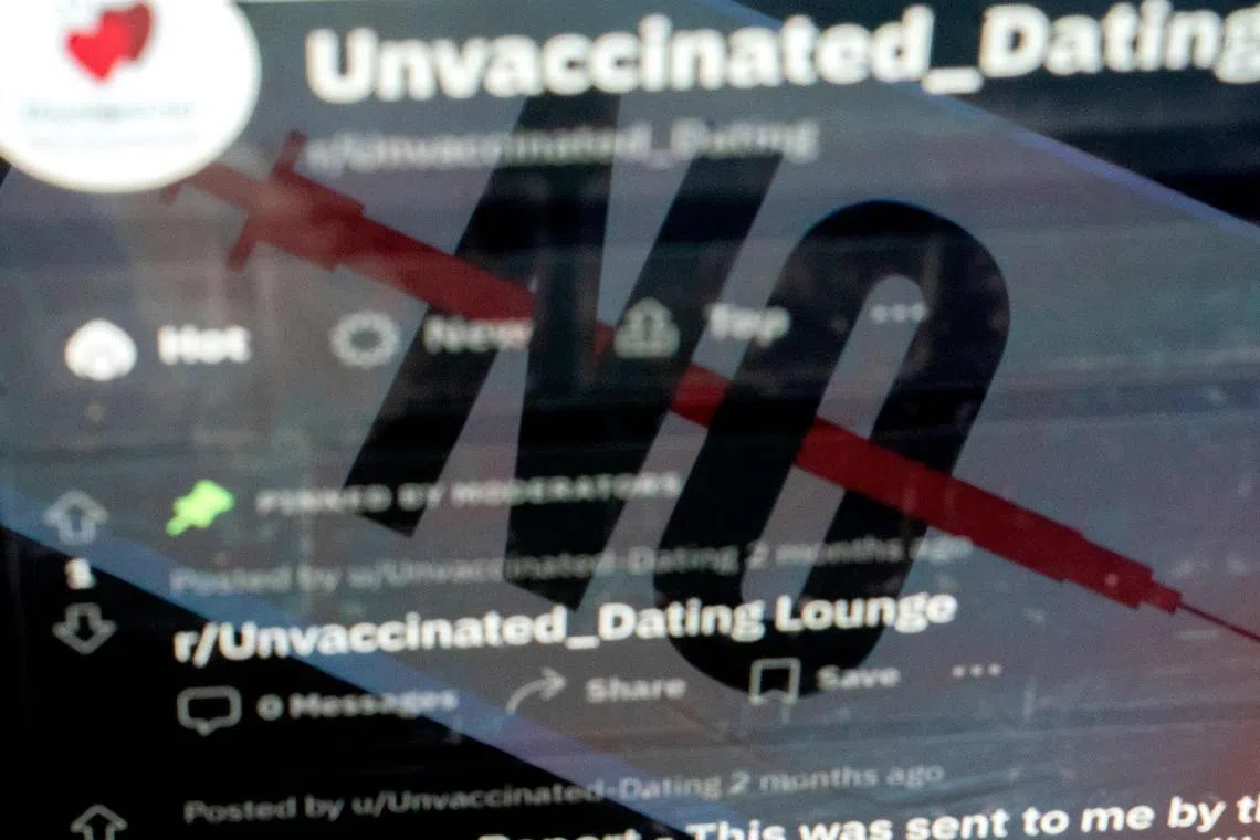 This photo illustration created in Washington, DC, on July 26, 2023, shows the cover image of a Facebook group for unvaccinated singles reflected in a reddit page for unvaccinated dating. The Covid-19 pandemic may have receded, but dating apps, websites and social media groups still offer to unite vaccine-hating singles who believe debunked falsehoods such as coronavirus jabs contaminate the bloodstream and cause infertility or autism. The trend underscores how the deeply polarizing anti-vaccine sentiment has become an entrenched identity for many who wilfully resist or ignore scientific assertions that inoculations saved tens of millions of lives globally when the pandemic was raging. (Photo by Stefani Reynolds / AFP)