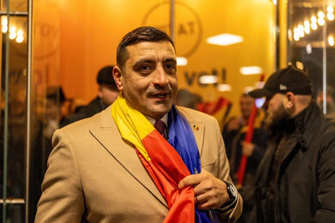 FILE PHOTO: Leader of the radical right Alliance for Uniting Romanians (AUR) George Simion looks on, following the first exit polls, at the party’s campaign headquarters, on the day of the parliamentary election, in Bucharest, Romania, December 1, 2024. REUTERS/Alkis Konstantinidis/File Photo