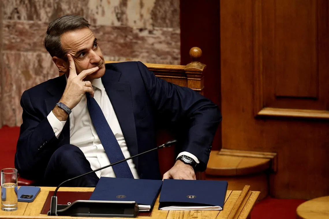 FILE PHOTO: Greek Prime Minister Kyriakos Mitsotakis gestures as leader of PASOK party Nikos Androulakis addresses lawmakers at the parliament ahead of a vote on confidence following a censure motion submitted by leftist and centre-left opposition parties, in Athens, Greece, March 28, 2024. REUTERS/Louiza Vradi