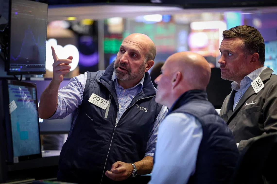 Specialist traders working inside a booth on the floor of the New York Stock Exchange, in New York City, on Sept 10.      