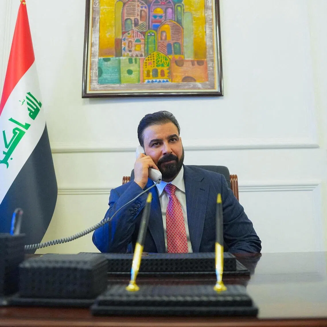 New Iraqi Prime Minister designate Ali al-Zaidi, uses a phone at his office in Baghdad, Iraq, on April 28.