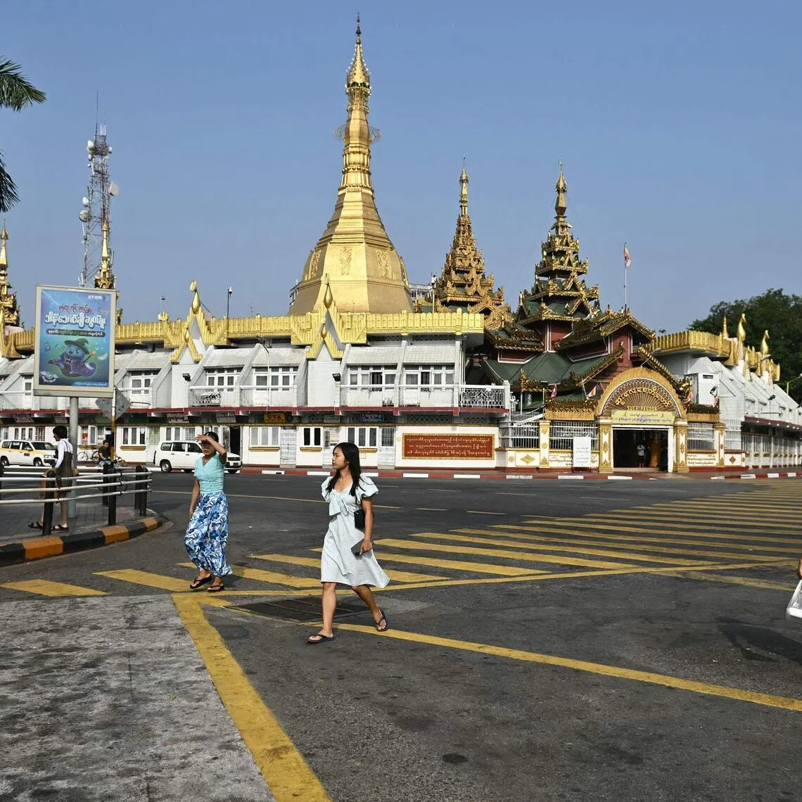 Pedestrian cross a road near Sule Pagoda in Yangon on March 7, 2026.