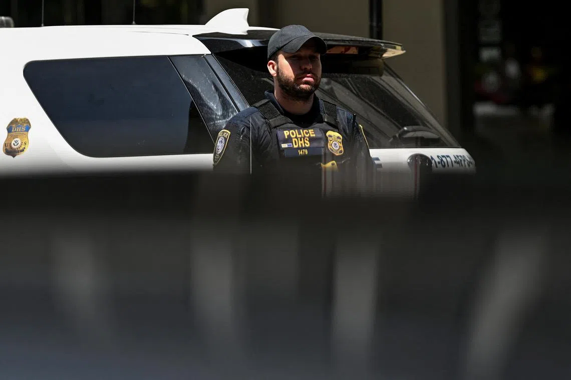 A Homeland Security police officer stands guard outside a building housing an immigration court amid federal immigration sweeps in Chicago, Illinois, U.S., June 16, 2025. REUTERS/Dylan Martinez