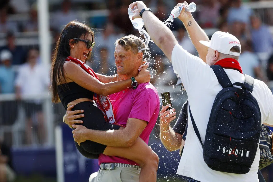 Adrian Meronk of Poland celebrating his win with his partner on the 18th green at the Australian Open.