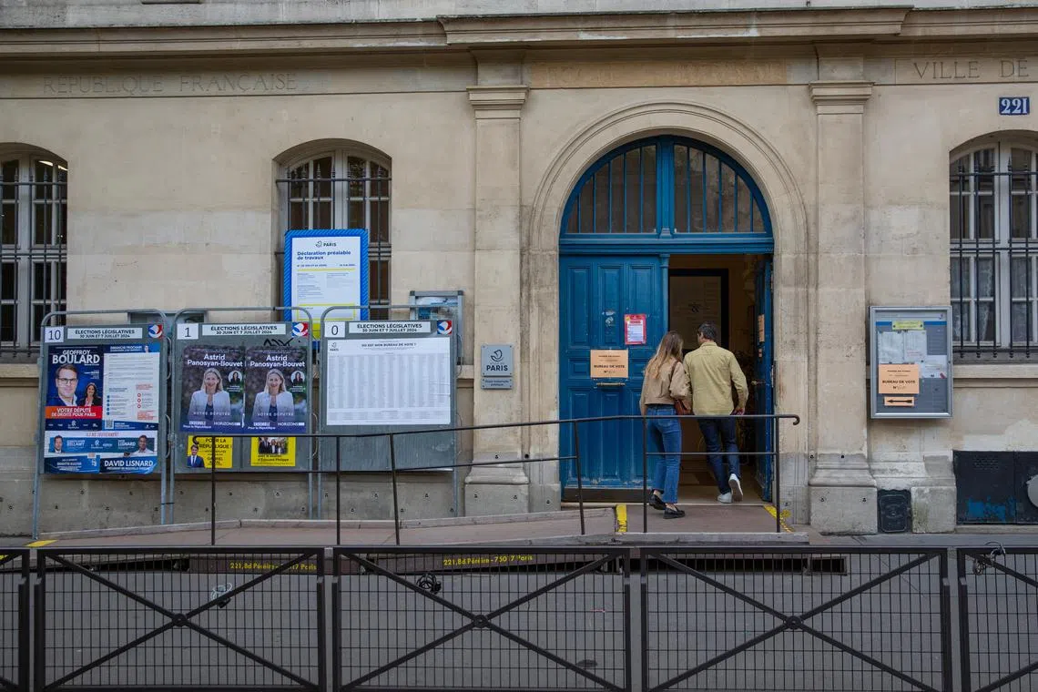 Voters arriving at a polling station in Paris on July 7.