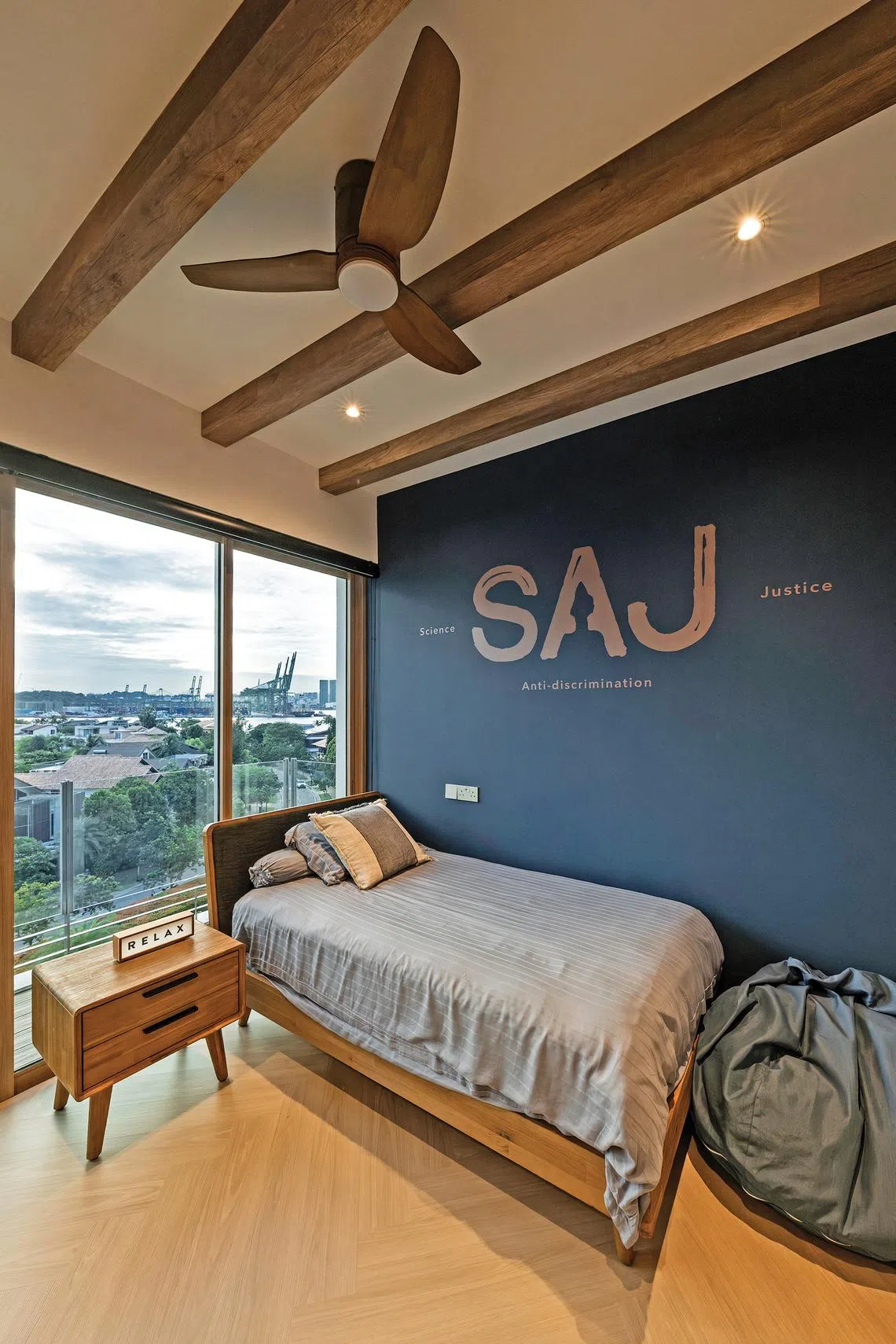 The navy blue walls of the son’s bedroom are emblazoned with virtues he values.
