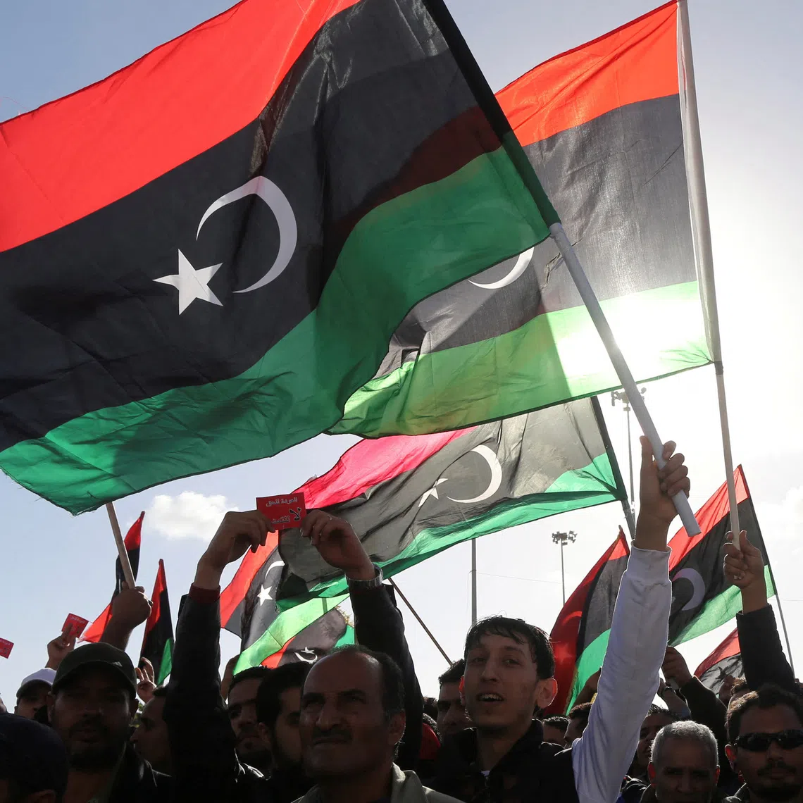 FILE PHOTO: People wave Libyan flags during a demonstration in Benghazi February 7, 2014.  REUTERS/Esam Omran Al-Fetori/File Photo