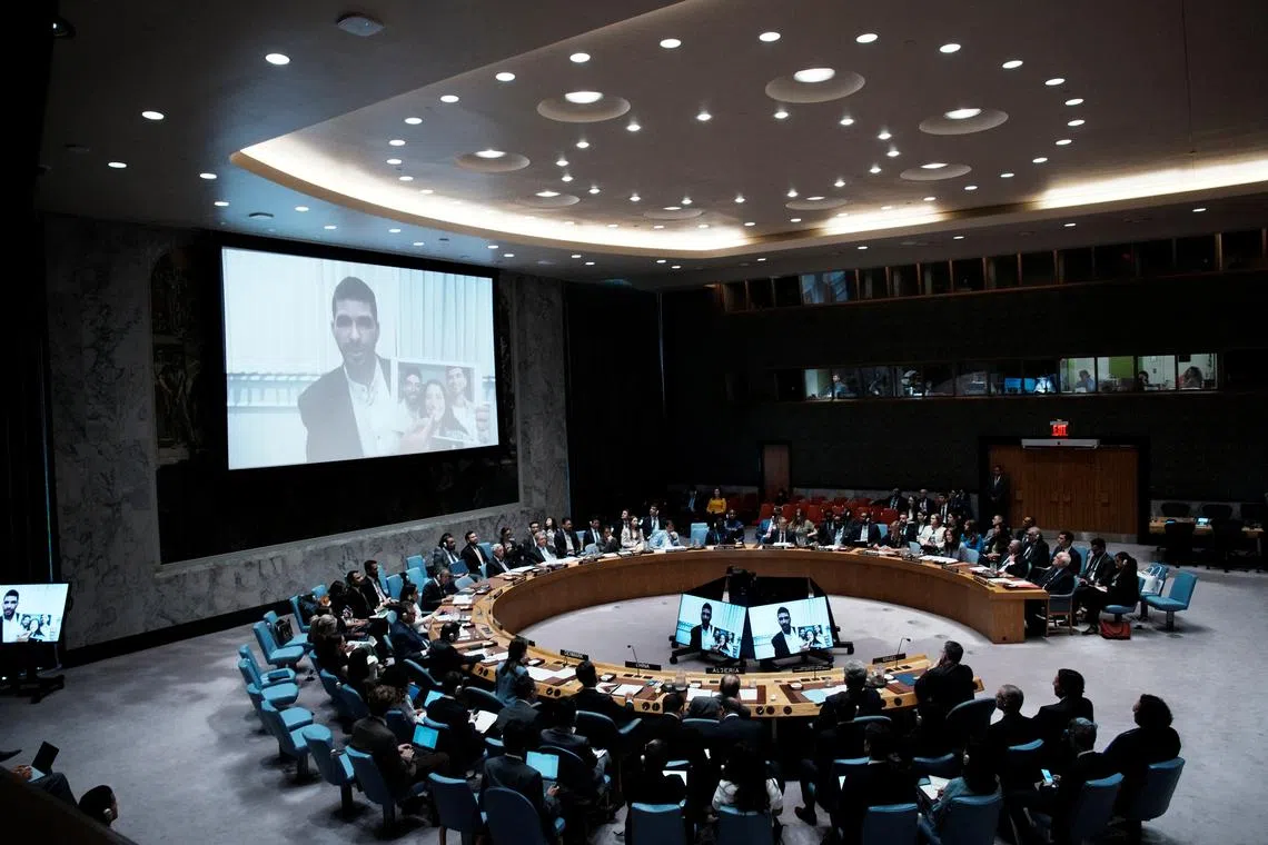 Ilay David is displayed on screen as he shows a picture of his family during a Security Council meeting at UN headquarters in New York City, U.S., August 5, 2025.  REUTERS/Eduardo Munoz