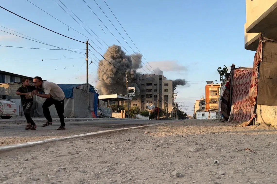 People run, as smoke and flames rise following an Israeli strike on a residential building, amid the ongoing conflict between Israel and Hamas, Nuseirat in the central Gaza Strip, in this screen grab taken from a video, August 17, 2024. Reuters TV via REUTERS