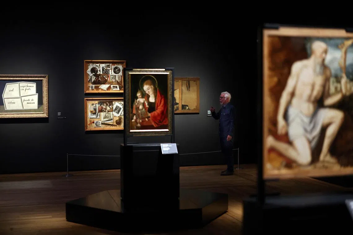Mr Miguel Angel Blanco, exhibition curator, gives some explanations about various paintings as part of the Reversos exhibition, which presents the hidden back sides of renowned paintings, at the Prado Museum in Madrid on Dec 5, 2023. 