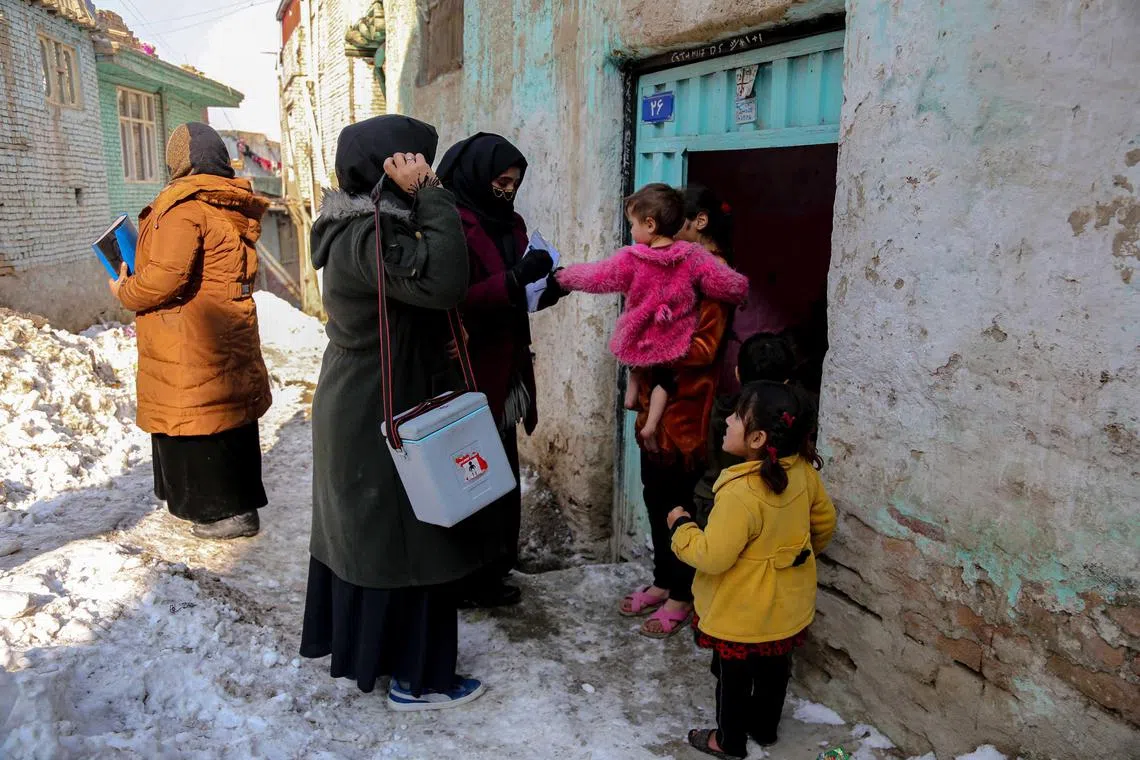 Health workers visit houses to administer polio vaccination to children in Kabul, Afghanistan, on Jan 25, 2023.