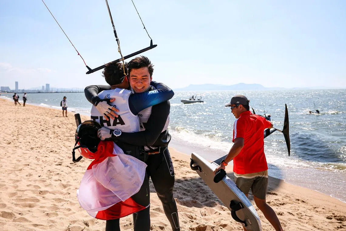 Maximilian Maeder (second from left) hugging Joseph Weston, the silver medallist from Thailand, after winning the men's Formula Kite on Dec 16.