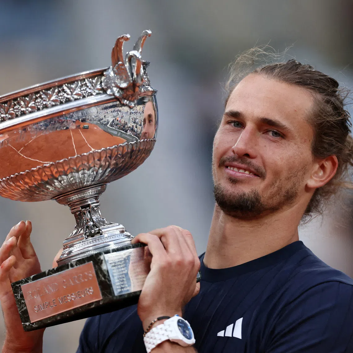 FILE PHOTO: Tennis - French Open - Roland Garros, Paris, France - June 7, 2026 Germany's Alexander Zverev celebrates with the trophy after winning the final against Italy's Flavio Cobolli REUTERS/Stephane Mahe/File Photo