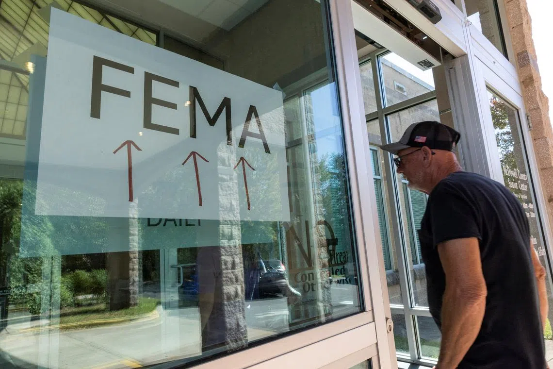 A resident enters a Fema's improvised station following the passing of Hurricane Helene, in Marion, North Carolina, on Oct 5, 2024. 