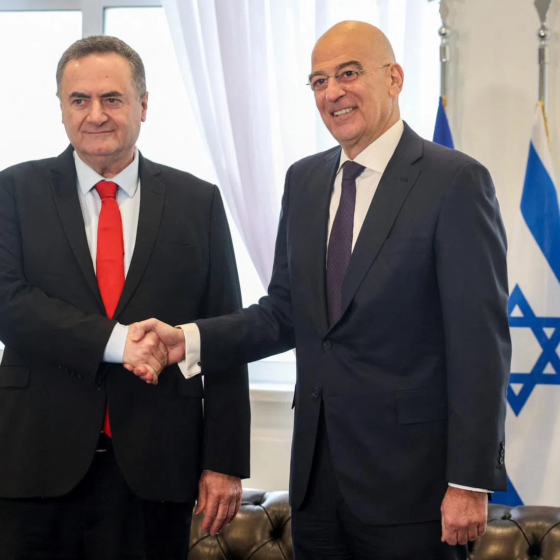 Israel's Defence Minister Israel Katz shakes hands with his Greek counterpart Nikos Dendias at the Ministry of Defence in Athens Greece, January 20, 2026. REUTERS/Louisa Gouliamaki