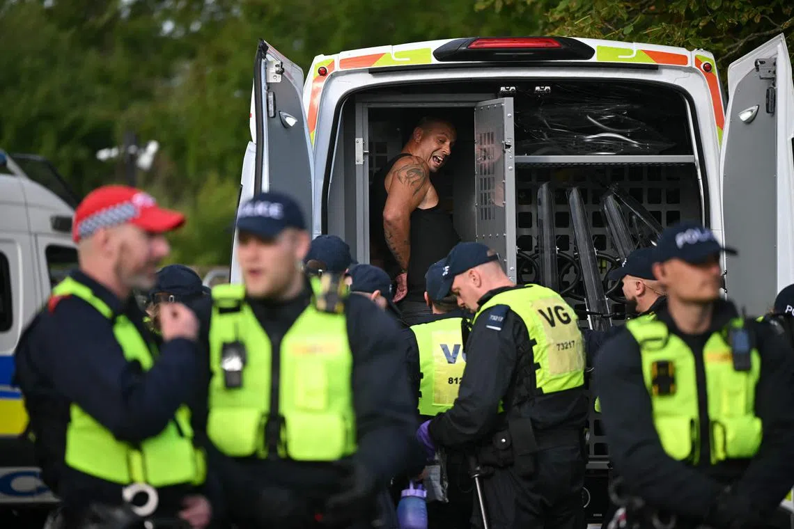 A man is arrested by police at a protest outside The Bell Hotel, in Epping, north-east  London, on July 20.