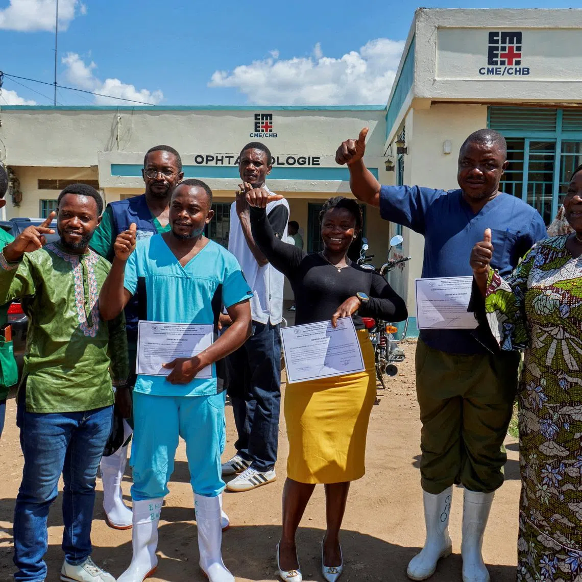 Congolese health workers who recovered from the Ebola virus pose for a photograph at the Evangelical Medical Center in Bunia on May 31.