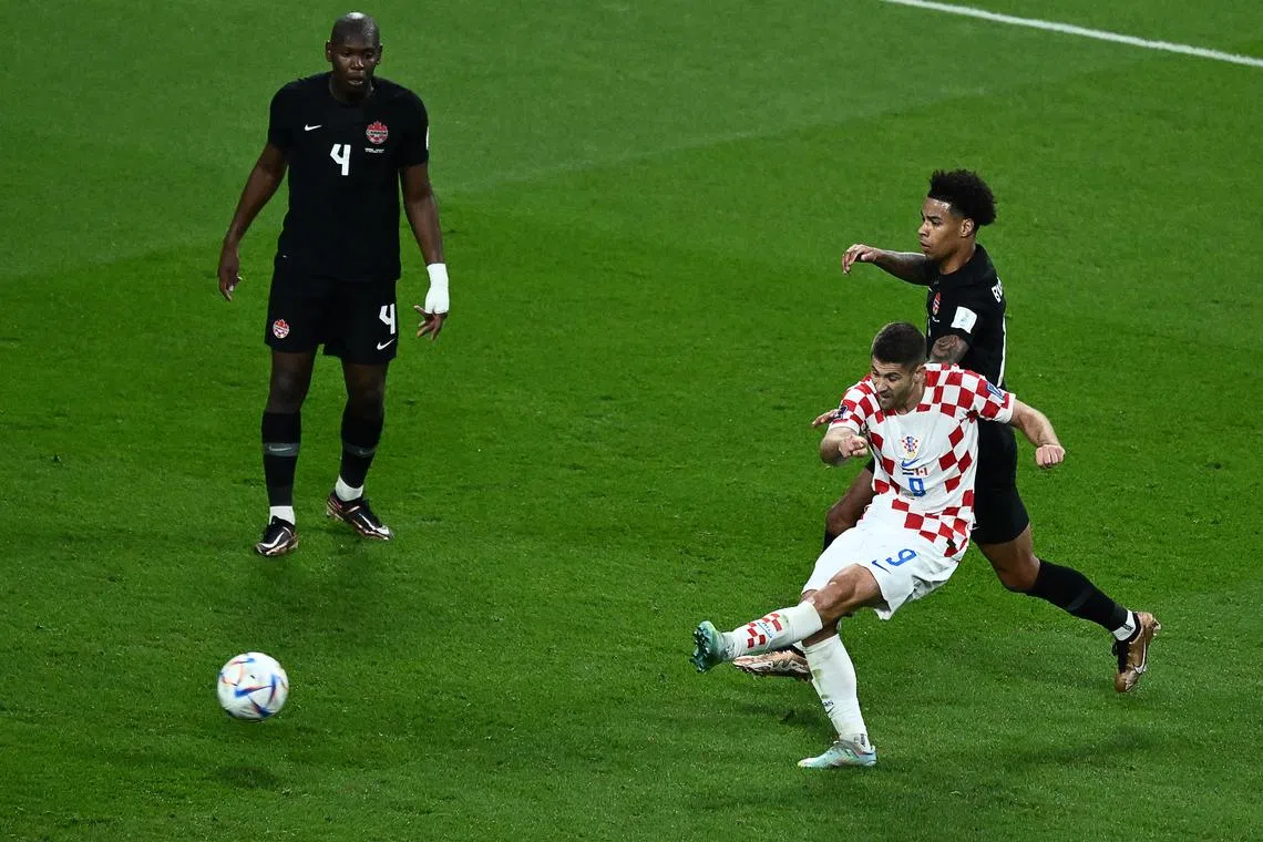 Croatia's Andrej Kramaric shoots and scores his team's third goal at the Khalifa International Stadium.