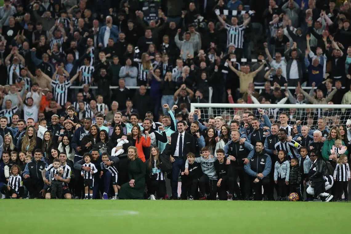 Newcastle United chairman Yasir Al-Rumayyan, directors Amanda Stavely, Mehrdad Ghodoussi and Jamie Reuben posing with the players, coaching staff and families during the lap of appreciation after qualifying for the Champions League.