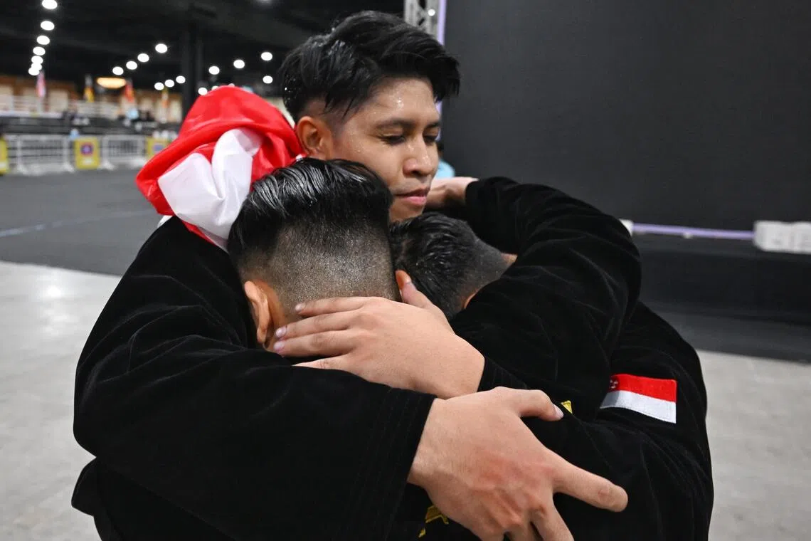 Singapore’s silat exponents embracing after their defeat in the men’s seni regu regu (artistic team) final on Dec 14.