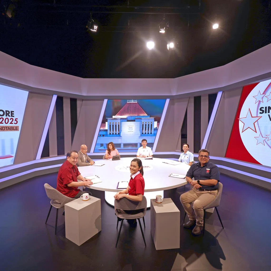 Presenter Otelli Edwards (in pink) with (clockwise from her left) PAP’s Chee Hong Tat, WP’s Michael Thng, RDU’s Ravi Philemon, PSP’s Stephanie Tan, PAR’s Lim Tean and expert Joseph Liow at the Mediacorp roundtable debate on April 27.