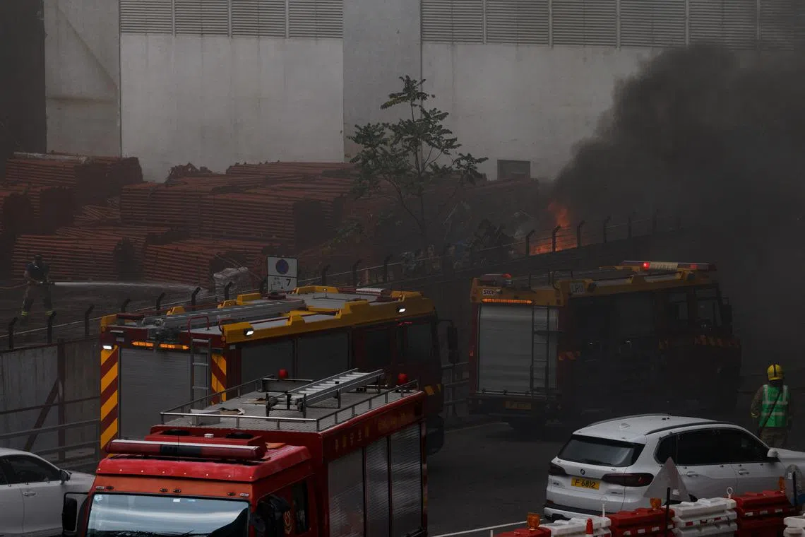 Fire trucks are parked near a warehouse blaze in the city's bustling Kowloon district, in Hong Kong.