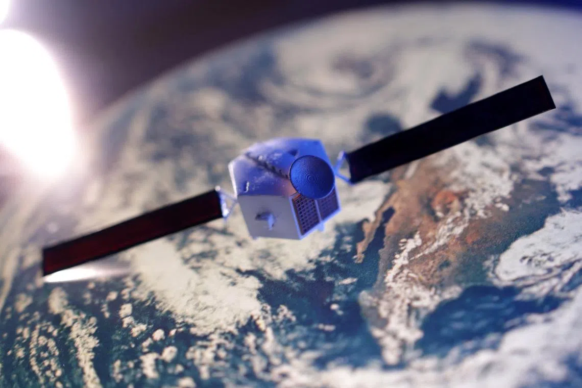 FILE PHOTO: A satellite model is placed on a picture of Earth in this illustration taken November 25, 2024. REUTERS/Dado Ruvic/Illustration/ File Photo