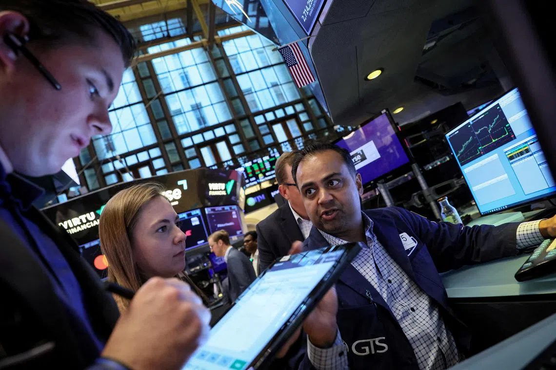 Traders work on the floor of the New York Stock Exchange, in New York City.