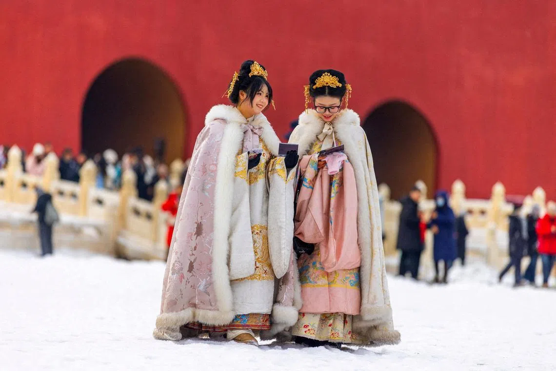 Two women in period costumes visiting the Forbidden City after snowfall in Beijing, China, on Jan 18, 2026. 