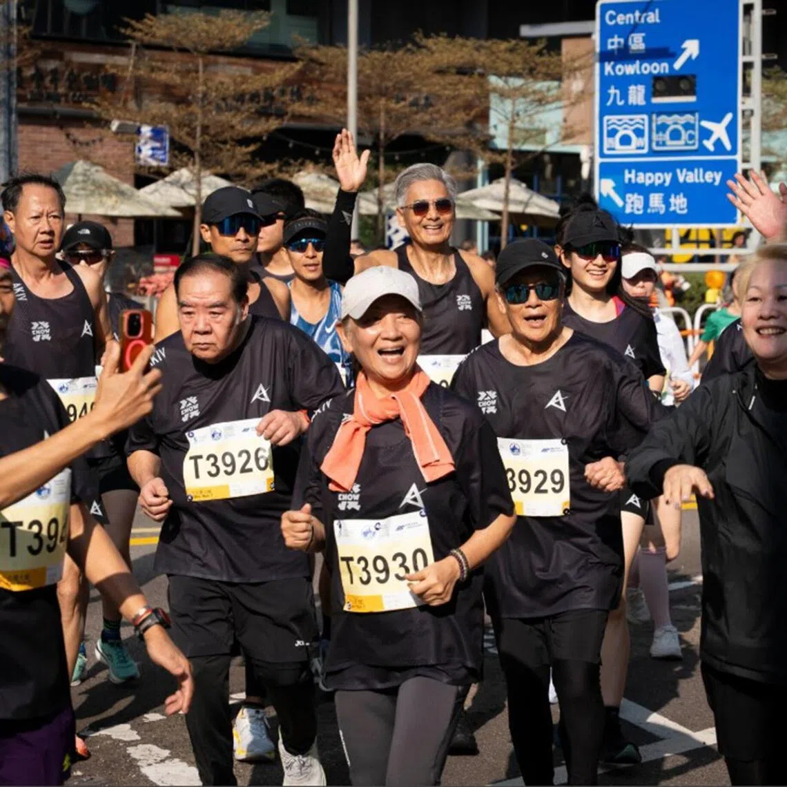 Chow Yun Fat (back row, middle, waving hand) with Kent Cheng (T3926), Nina Paw (T3930) and Lau Kong (T3929) at the Standard Chartered Hong Kong Marathon on Jan 18.