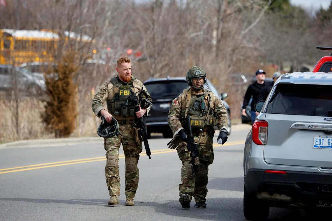 FILE PHOTO: FBI members work on the site after the Michigan State Police reported an active shooting incident at the Temple Israel Synagogue in West Bloomfield, Michigan, U.S., March 12, 2026. REUTERS/Rebecca Cook/File Photo