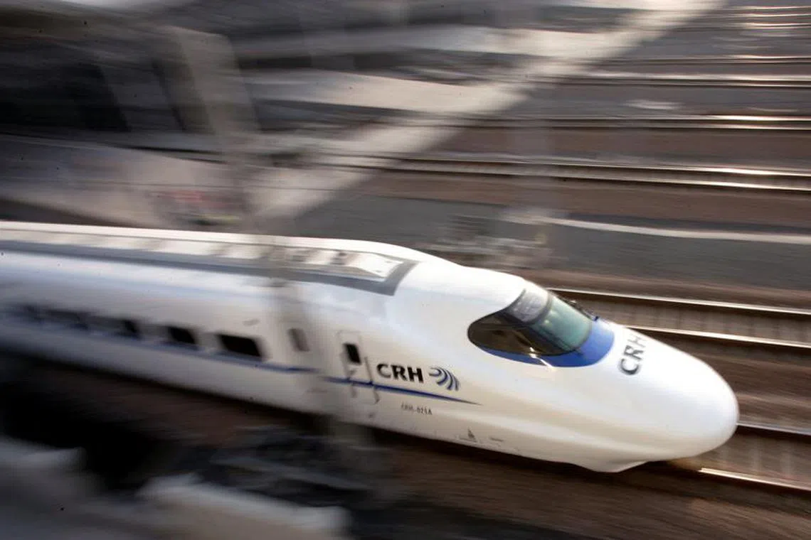 FILE PHOTO: A bullet train speeds during its debut near a railway station in Shanghai January 28, 2007. REUTERS/Aly Song (CHINA)/File Photo