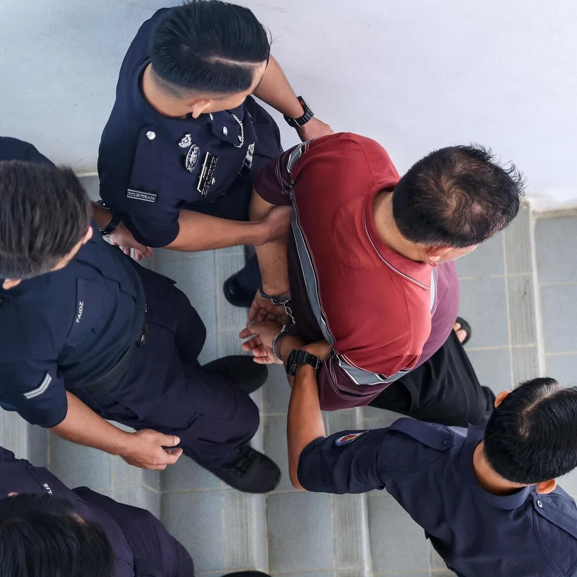 The suspect, who arrived at the court complex at about 9am on April 20, was seen handcuffed as he was brought in by police officers.