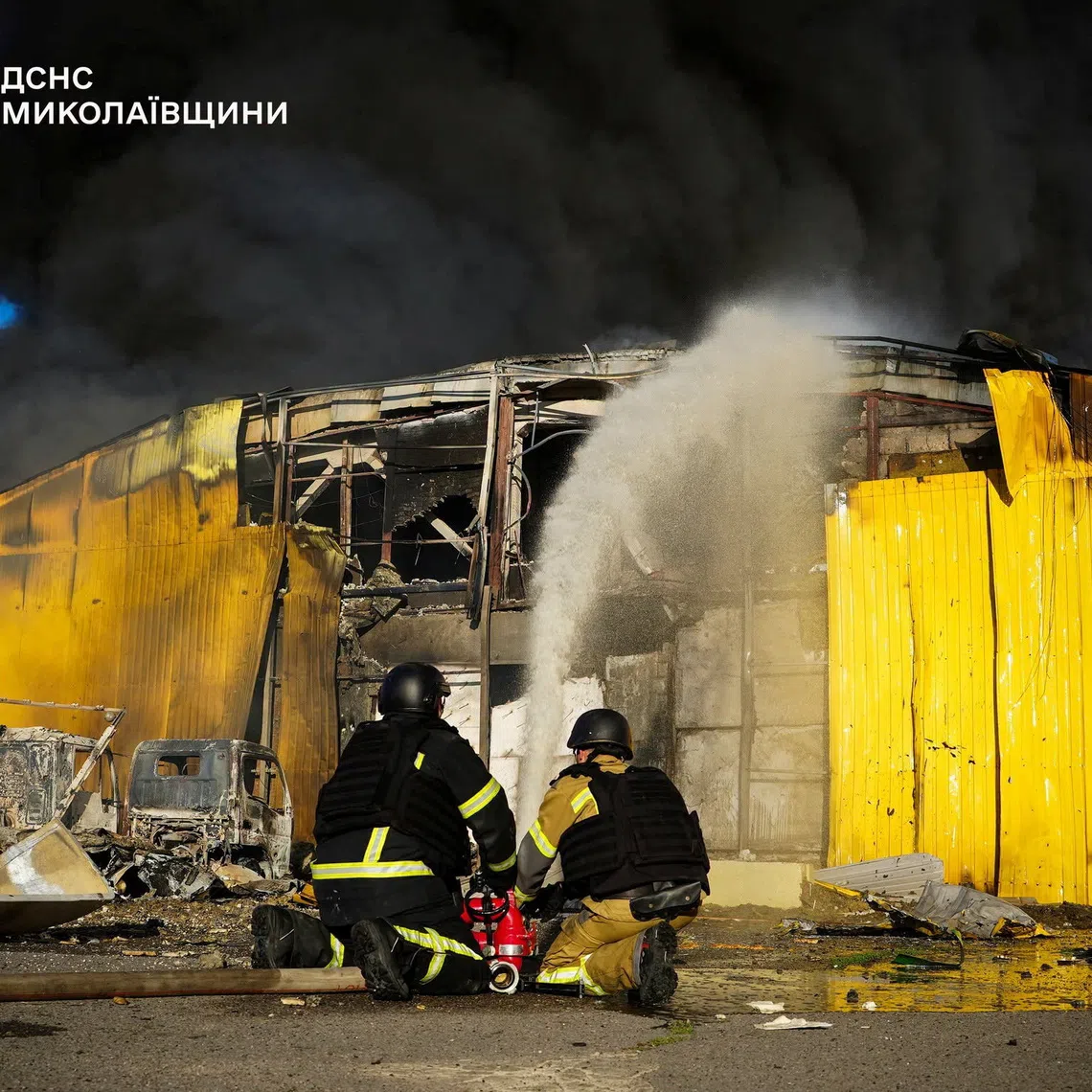 Firefighters working at the site of a warehouse hit during a wave of Russian drone and air strikes on Sept 9, in Mykolaiv, Ukraine.