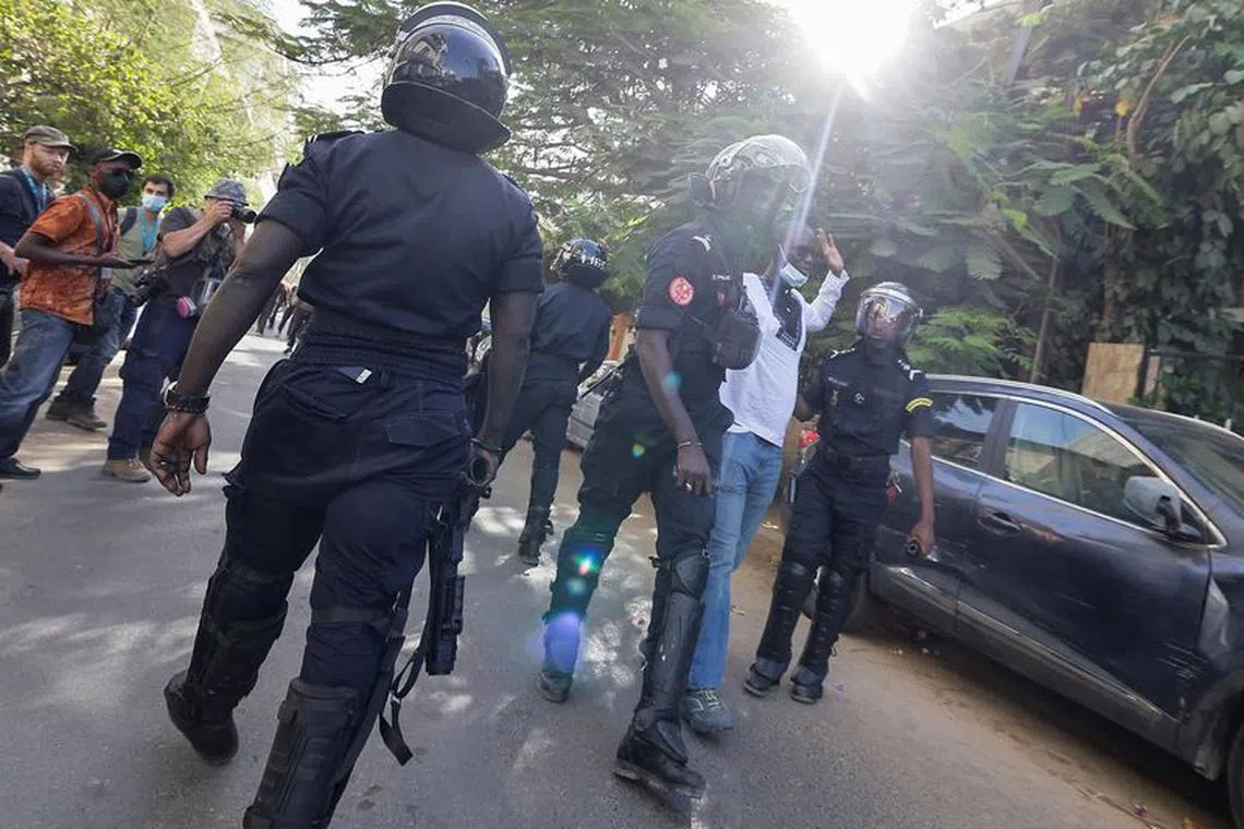 Riot police officers detain a protester who was gathering with others  to protest the postponement of the February 25 presidential election, near  Senegal's National Assembly in Dakar, Senegal February 5, 2024. REUTERS/Zohra Bensemra/File Photo