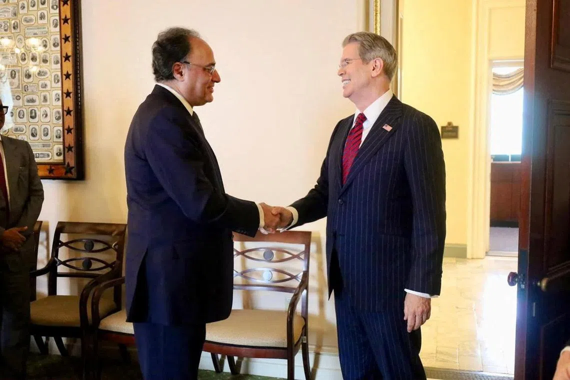 Pakistani Finance Minister Muhammad Aurangzeb and U.S. Treasury Secretary Scott Bessent shake hands as they meet in Washington, D.C., U.S., July 21, 2026. Ministry of Finance/Handout via REUTERS