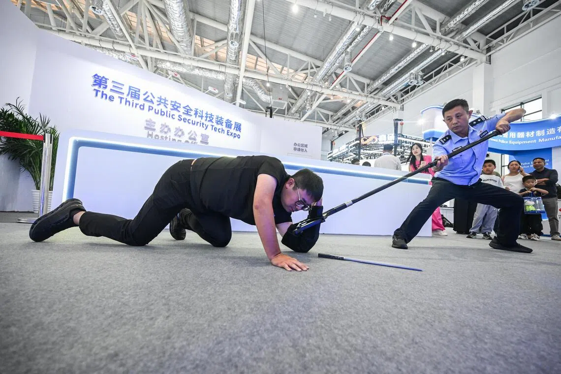 Police officer Zhang Tengfei, demostrating the Feiteng Smart Trapper, at the Public Security Tech Expo in Lianyungang, Jiangsu on Sept 10.