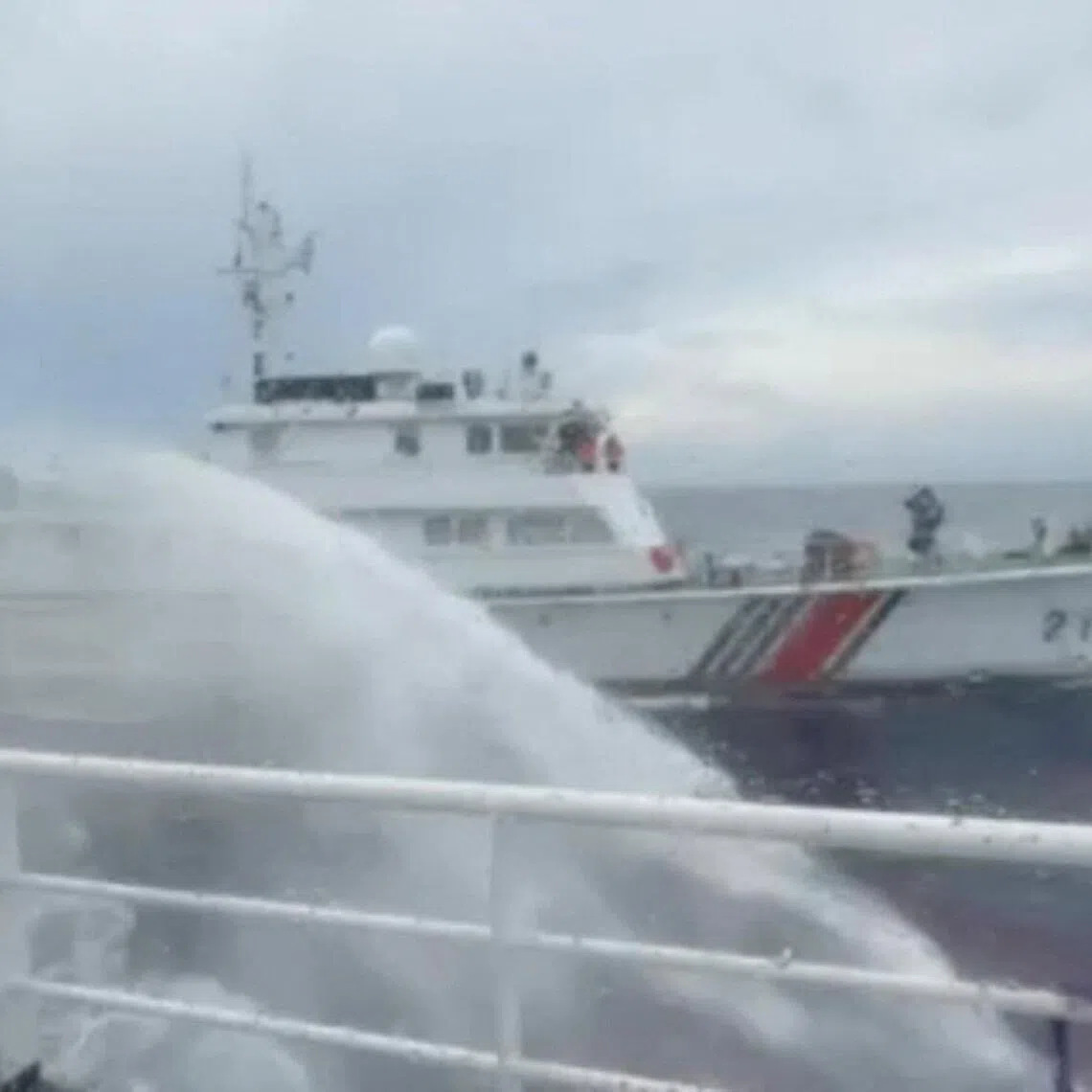 A Chinese coast guard ship reportedly firing a water cannon at a Philippine vessel in July 2026, near Scarborough Shoal, in the disputed South China Sea.