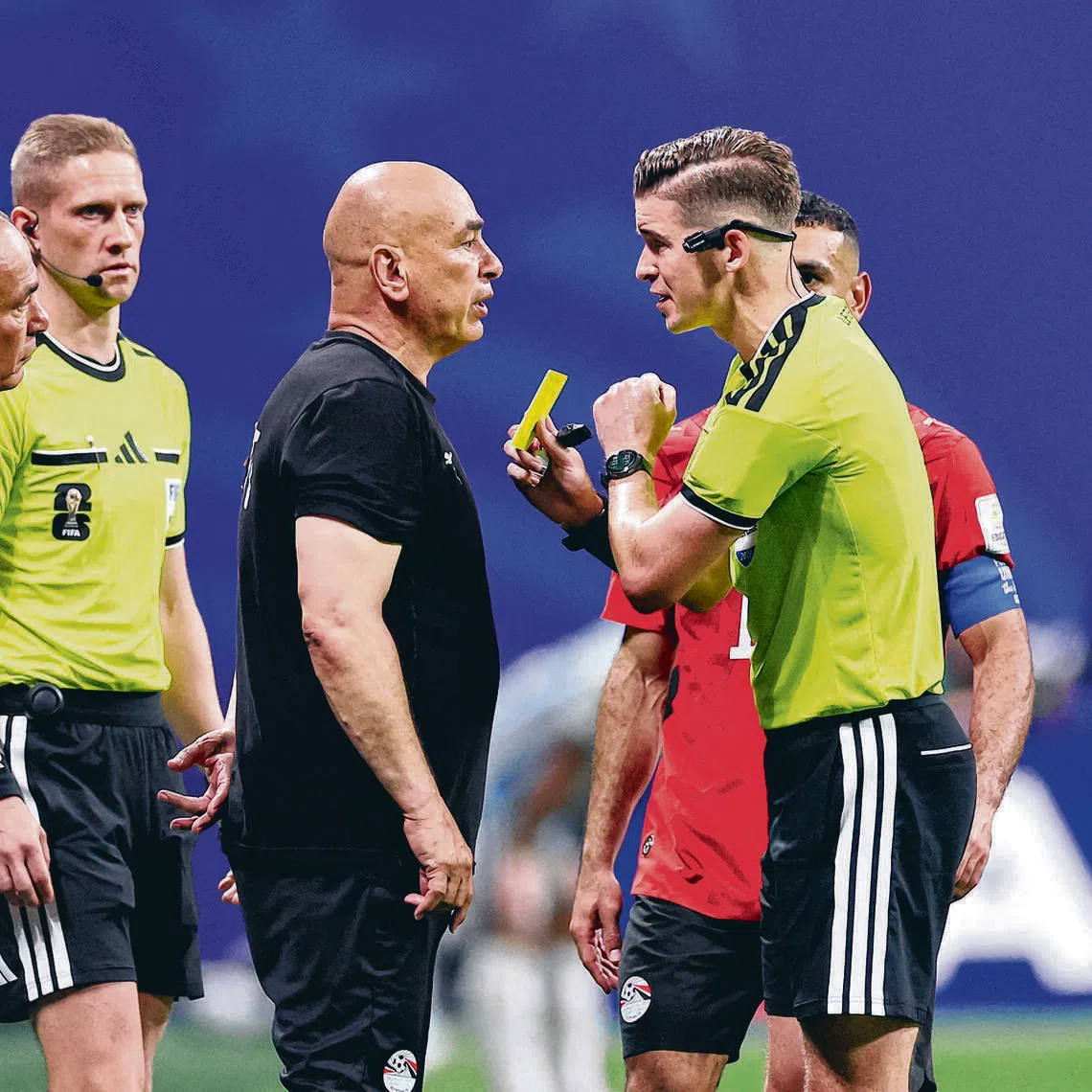 Referee Francois Letexier showing a yellow card to Egypt coach Hossam Hassan in their round of 16 match against Argentina on July 7.
