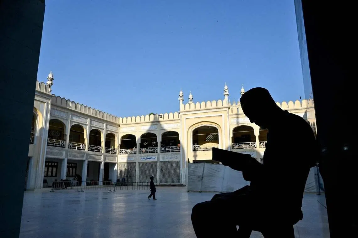 A Muslim devotee reciting from the holy Quran as he observes Itikaf, a spiritual retreat in a mosque during the Islamic holy fasting month of Ramadan in Karachi, Pakistan, on March 10.