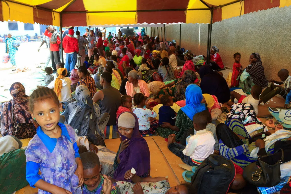 Ethiopians sit at a holding ground after fights erupted in the Ethiopian border town of Moyale, Kenya, October 23, 2026. REUTERS/REUTERS/Adduba Hussein