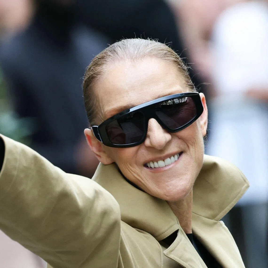 Canadian singer Celine Dion acknowledges fans as she arrives at Hotel Le Royal Monceau in Paris on Aug 28.
